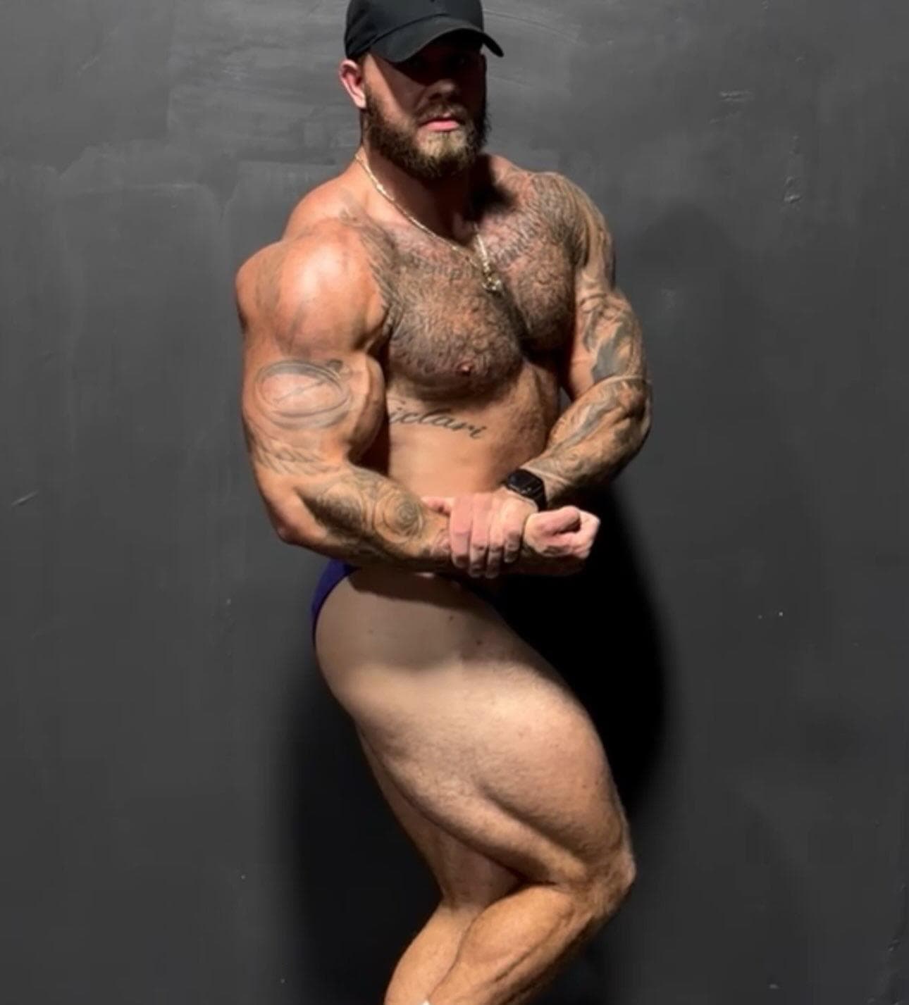 Sic Fitness coach hitting a side chest pose